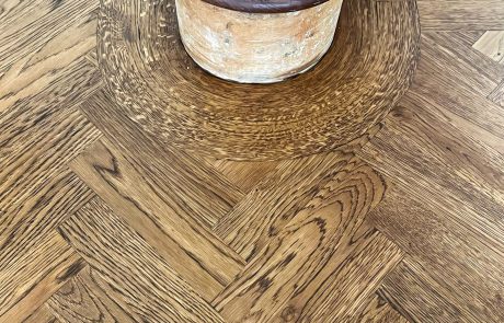 Curved timber border around staircase Curved timber border around staircase newel post in parquet floor