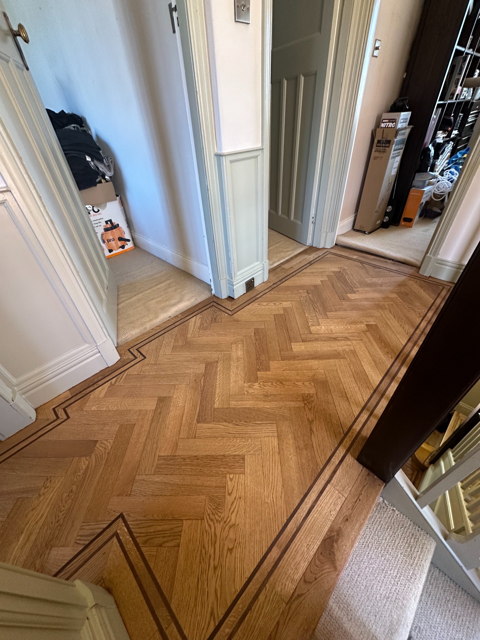 Oak herringbone flooring with a double walnut border