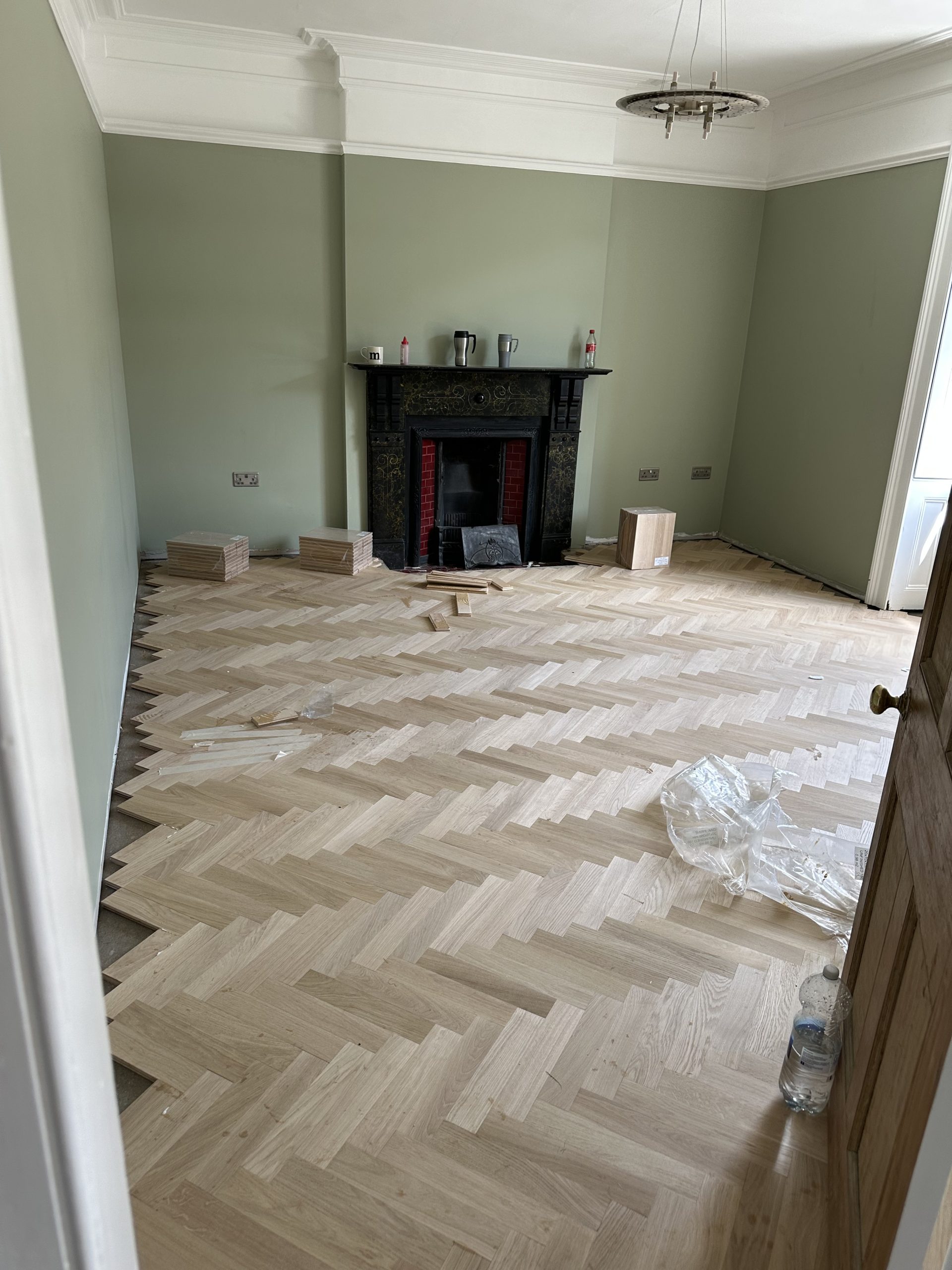 Oak herringbone field being installed before the perimeter is cut for the border