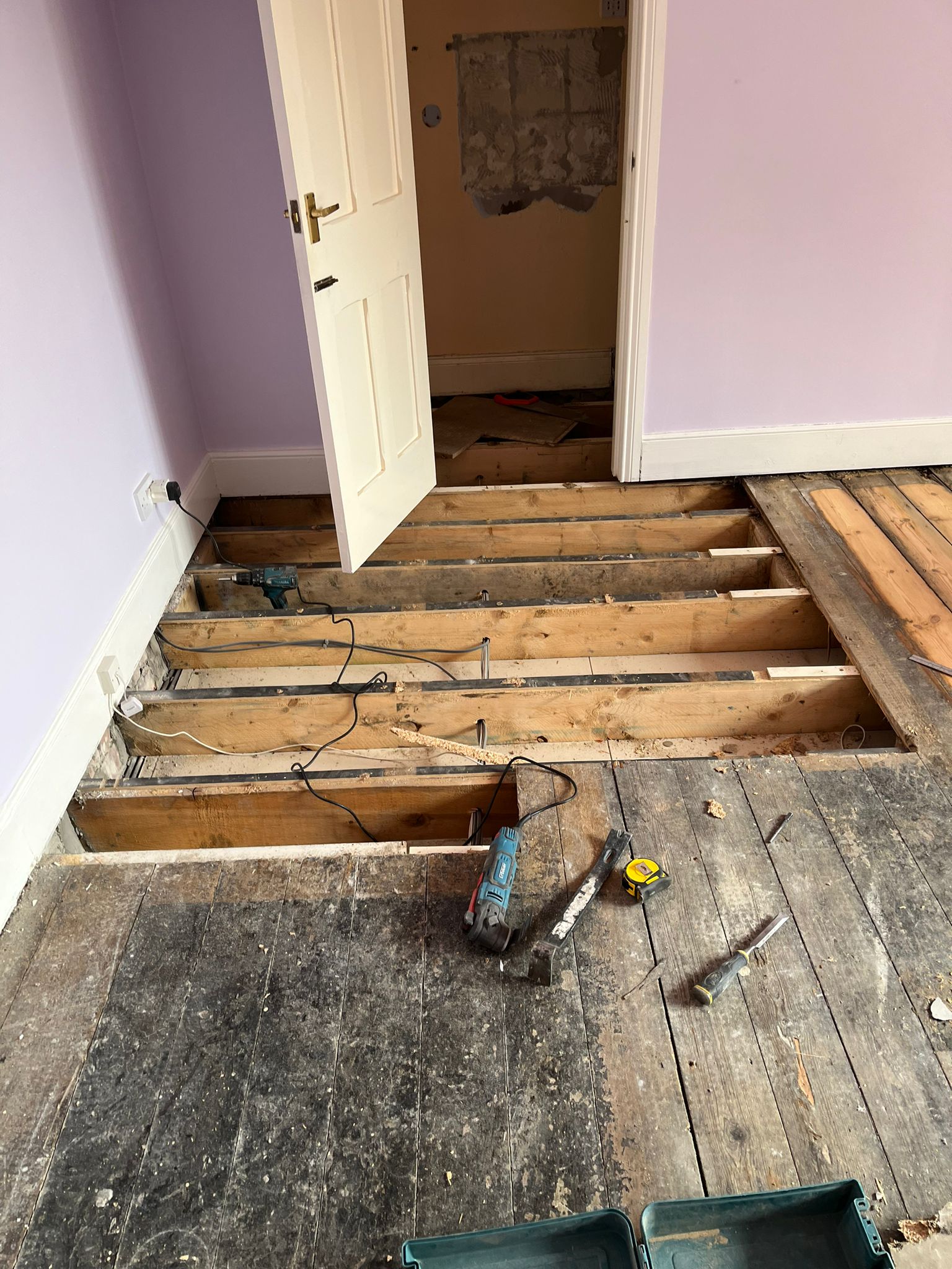 Removing the Previous Chipboard Floor Repair Previous chipboard repair removed from original softwood floor