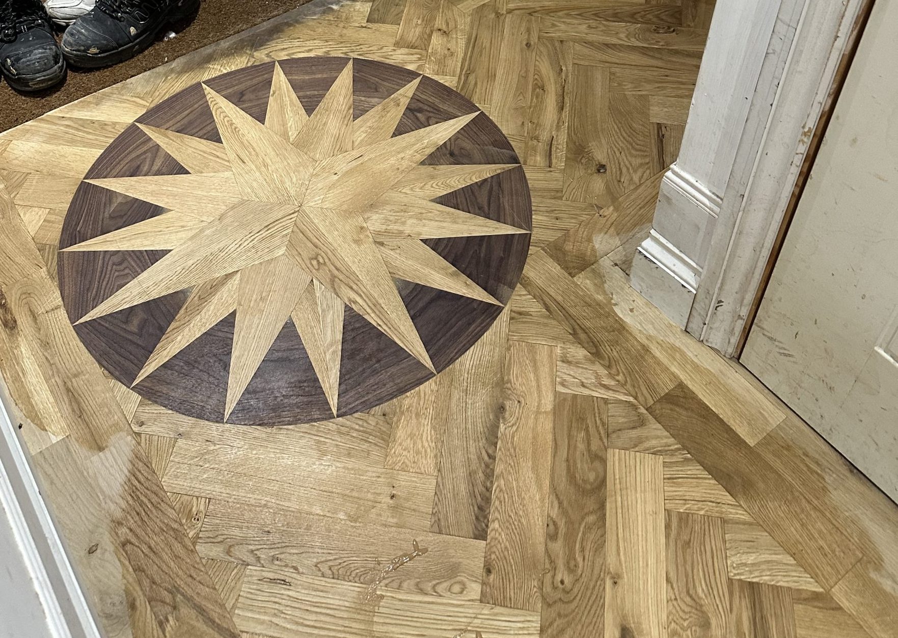 Installing the Oak and Walnut Medallion Oak and walnut medallion being installed into a herringbone floor