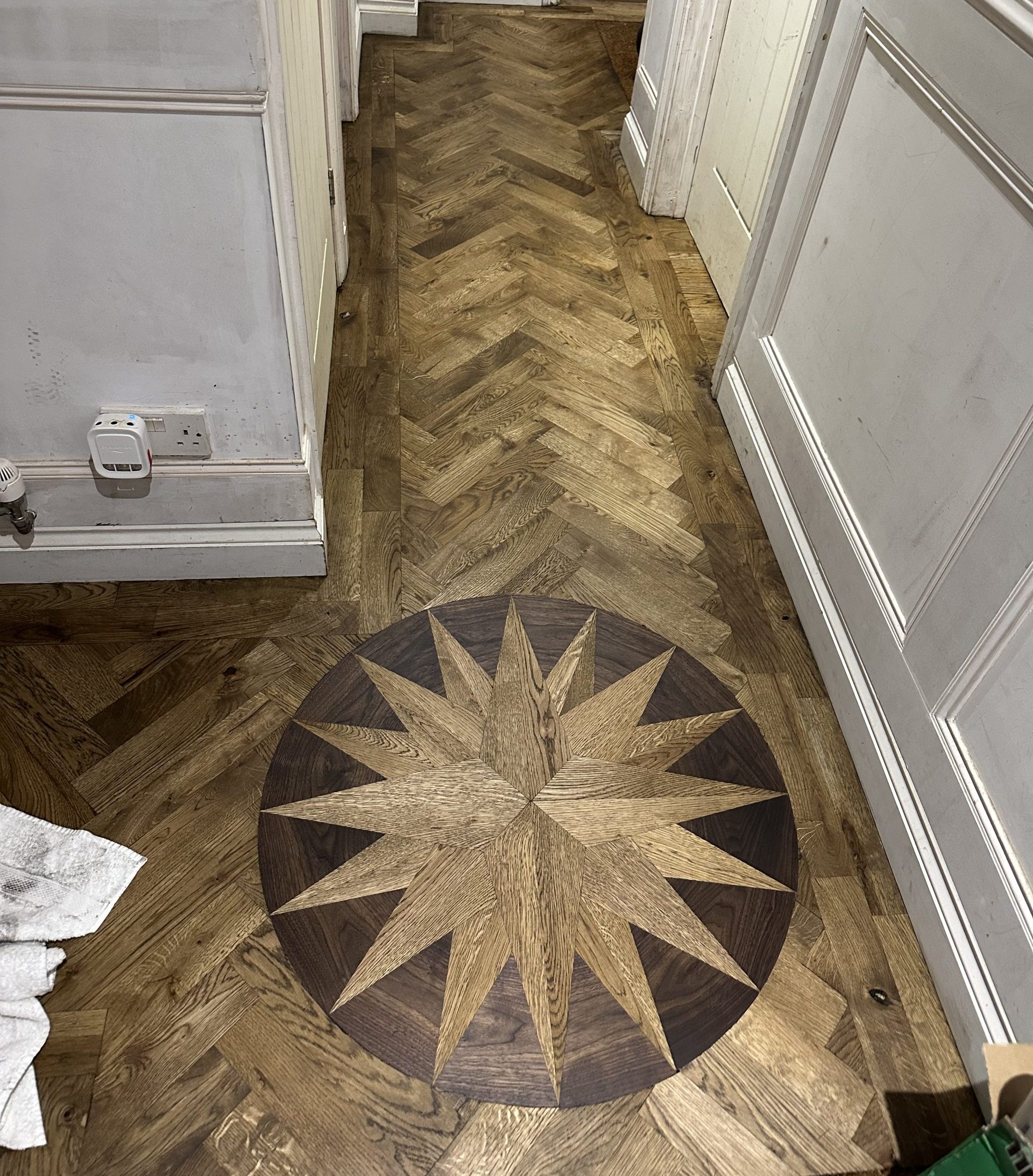 Finished Oak and Walnut Medallion Floor Finished oak and walnut medallion within an oak herringbone floor
