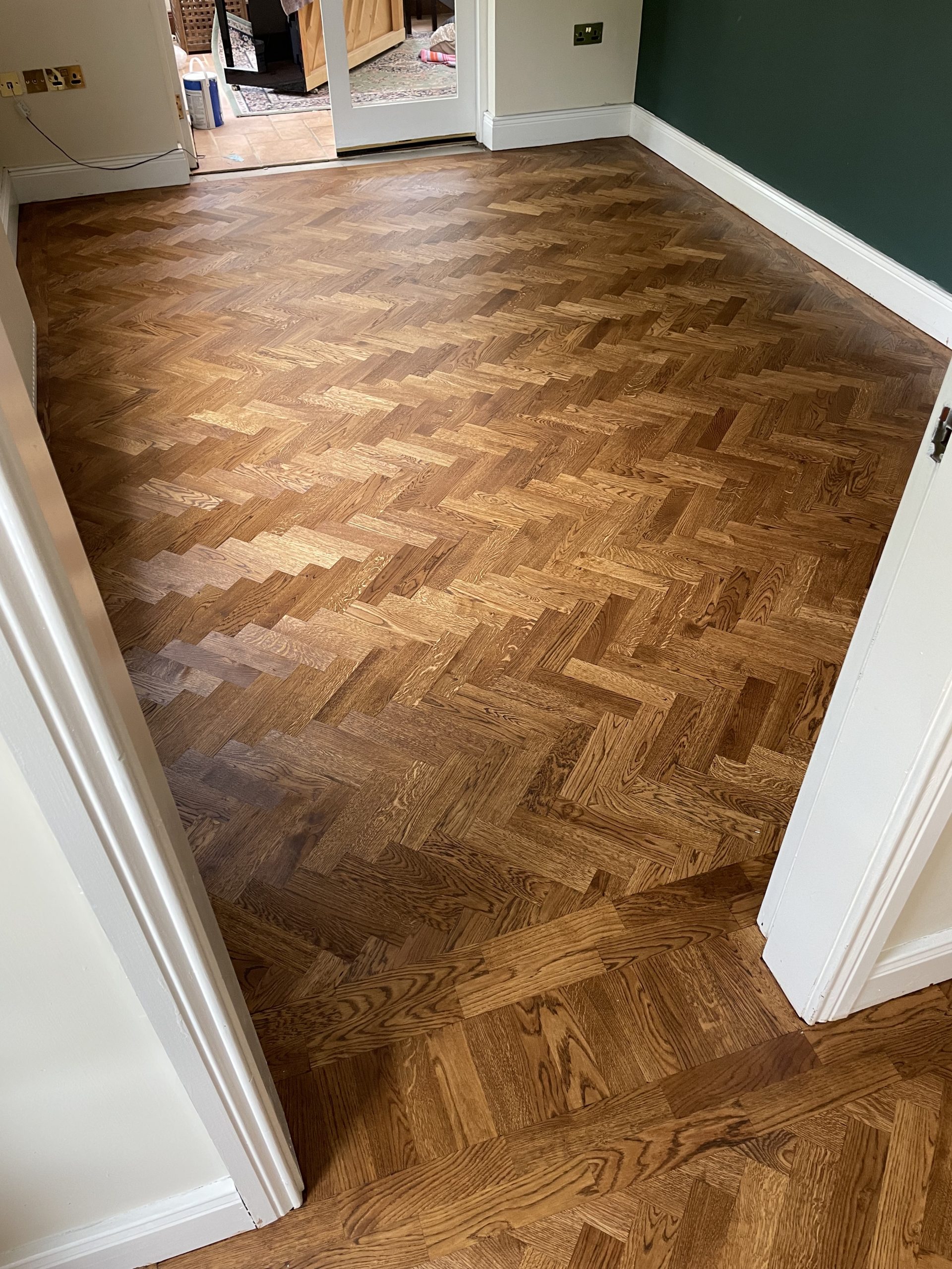 Oak herringbone flooring with coloured oil finish and two-block border in Shotley Bridge