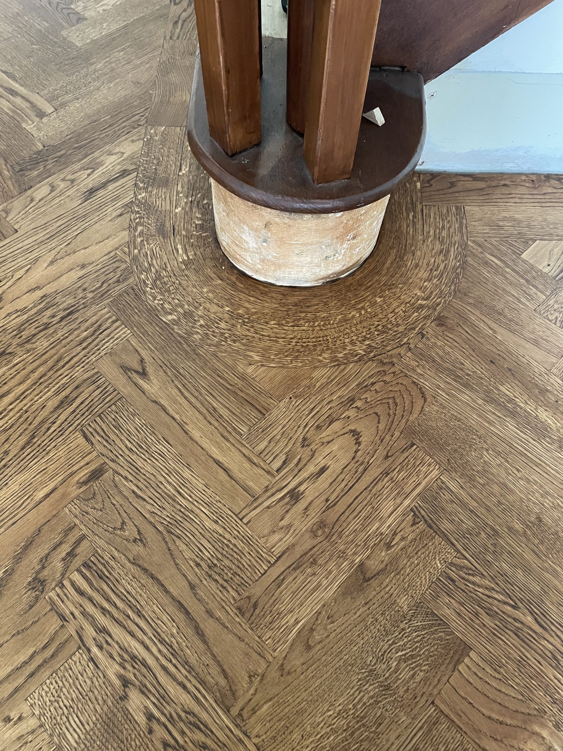 Bespoke curved oak flooring border fitted around a timber staircase in Shotley Bridge