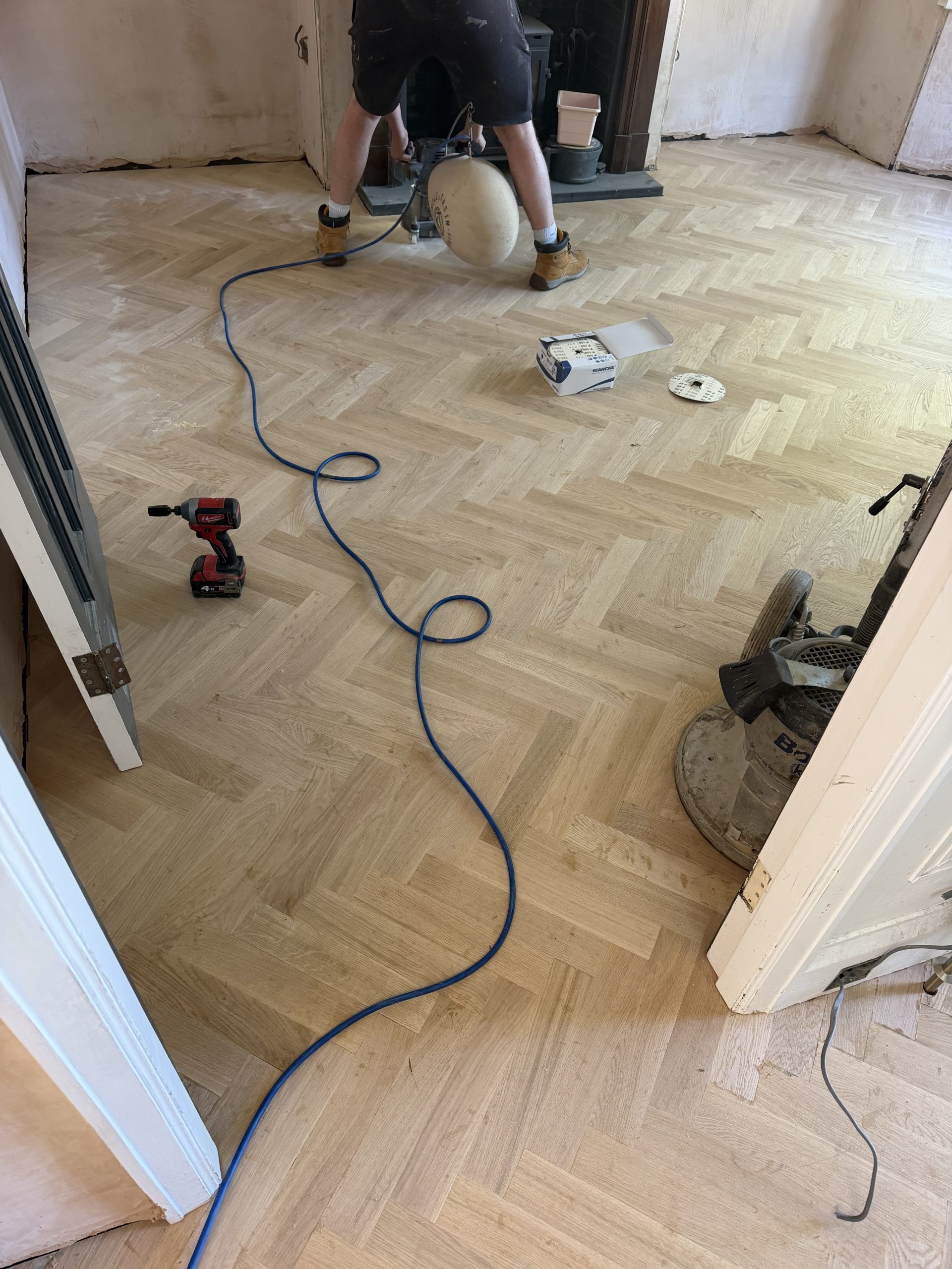 Sanding Solid Oak Herringbone Flooring – Tynemouth Solid oak herringbone flooring being sanded after installation in a Tynemouth home