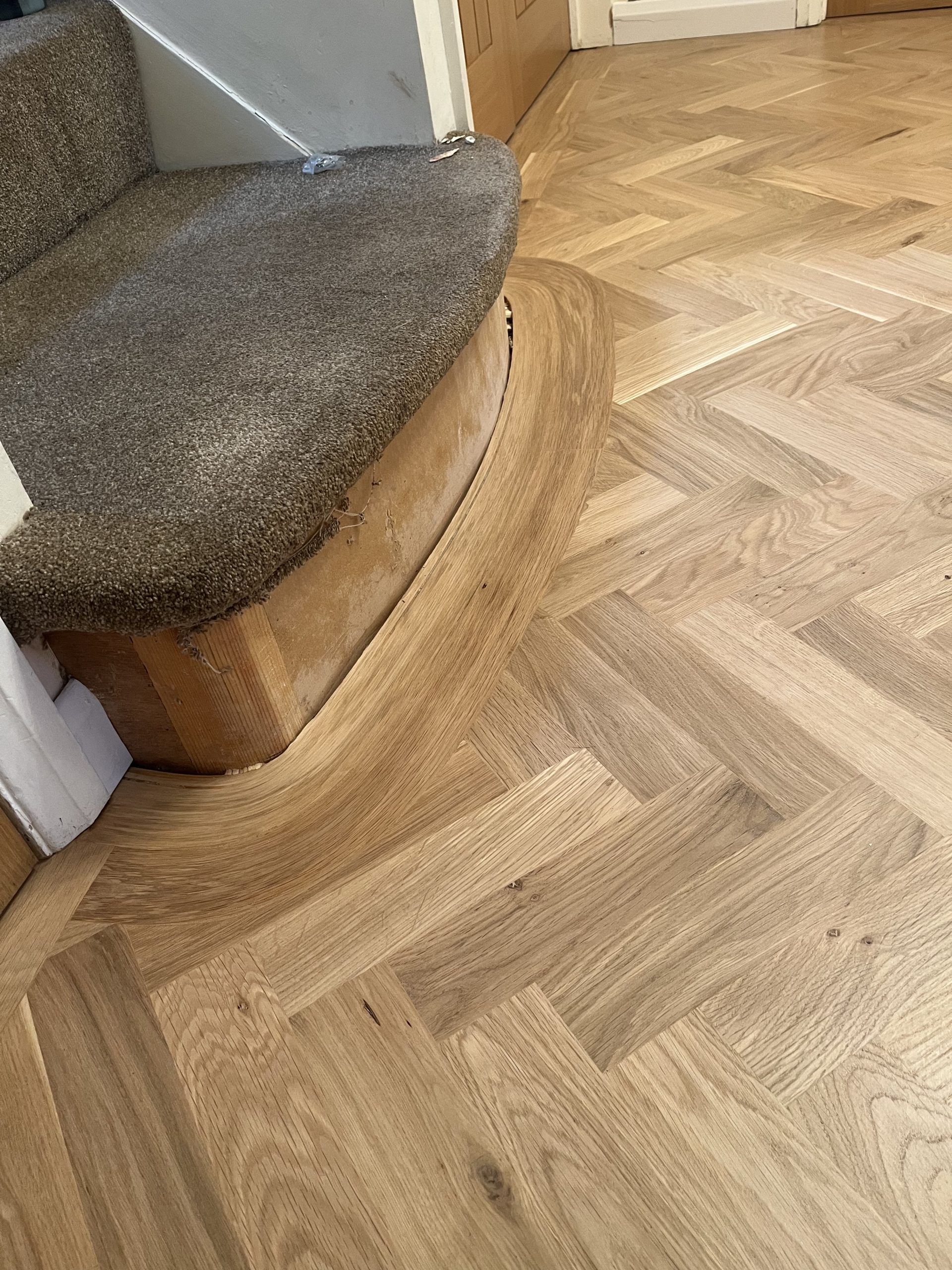 Curved Oak Border Around Rounded Step Oak parquet flooring with a wide curved border following a rounded step