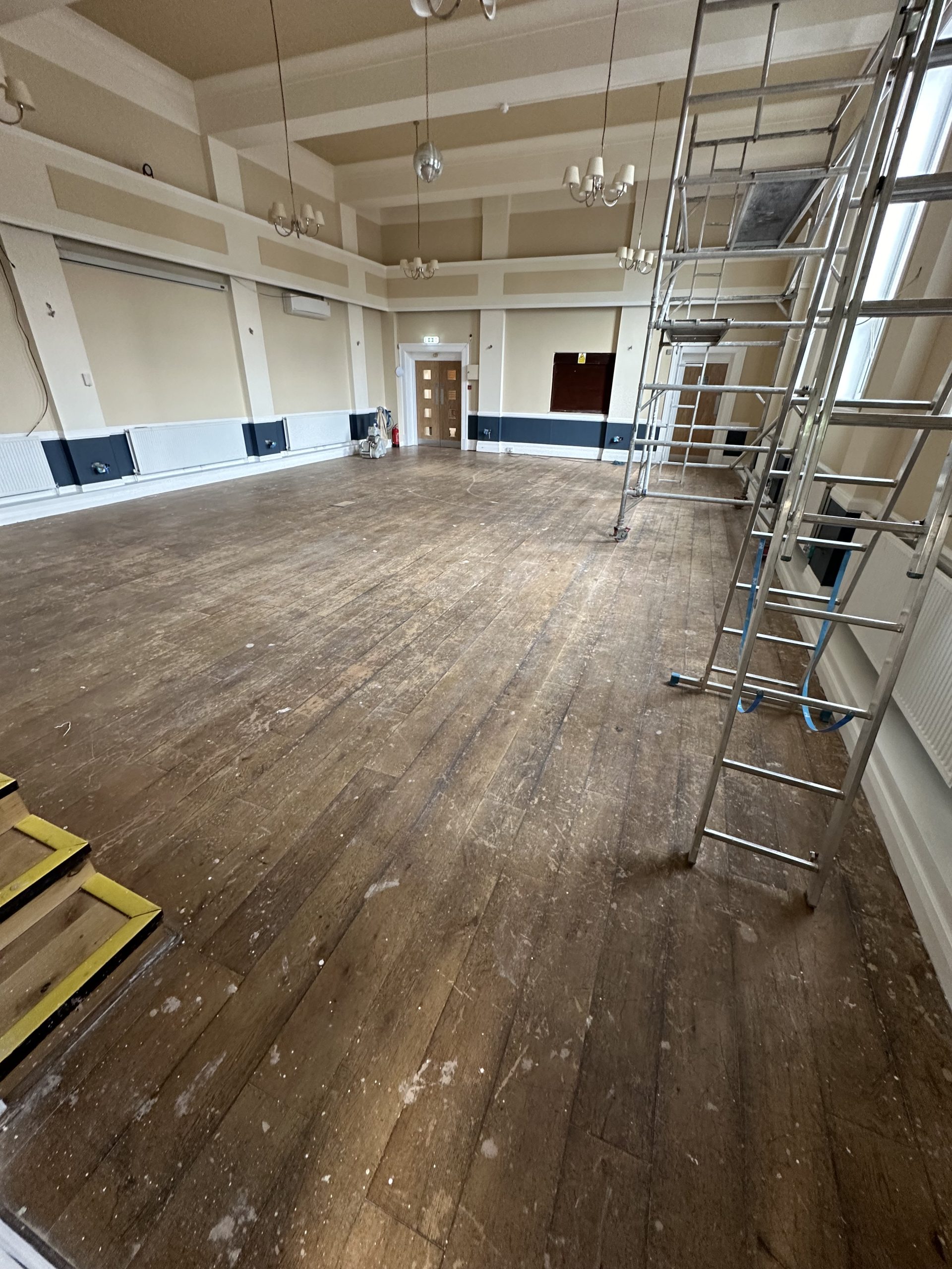Large Masonic hall in Chester-le-Street showing the worn oak flooring before restoration