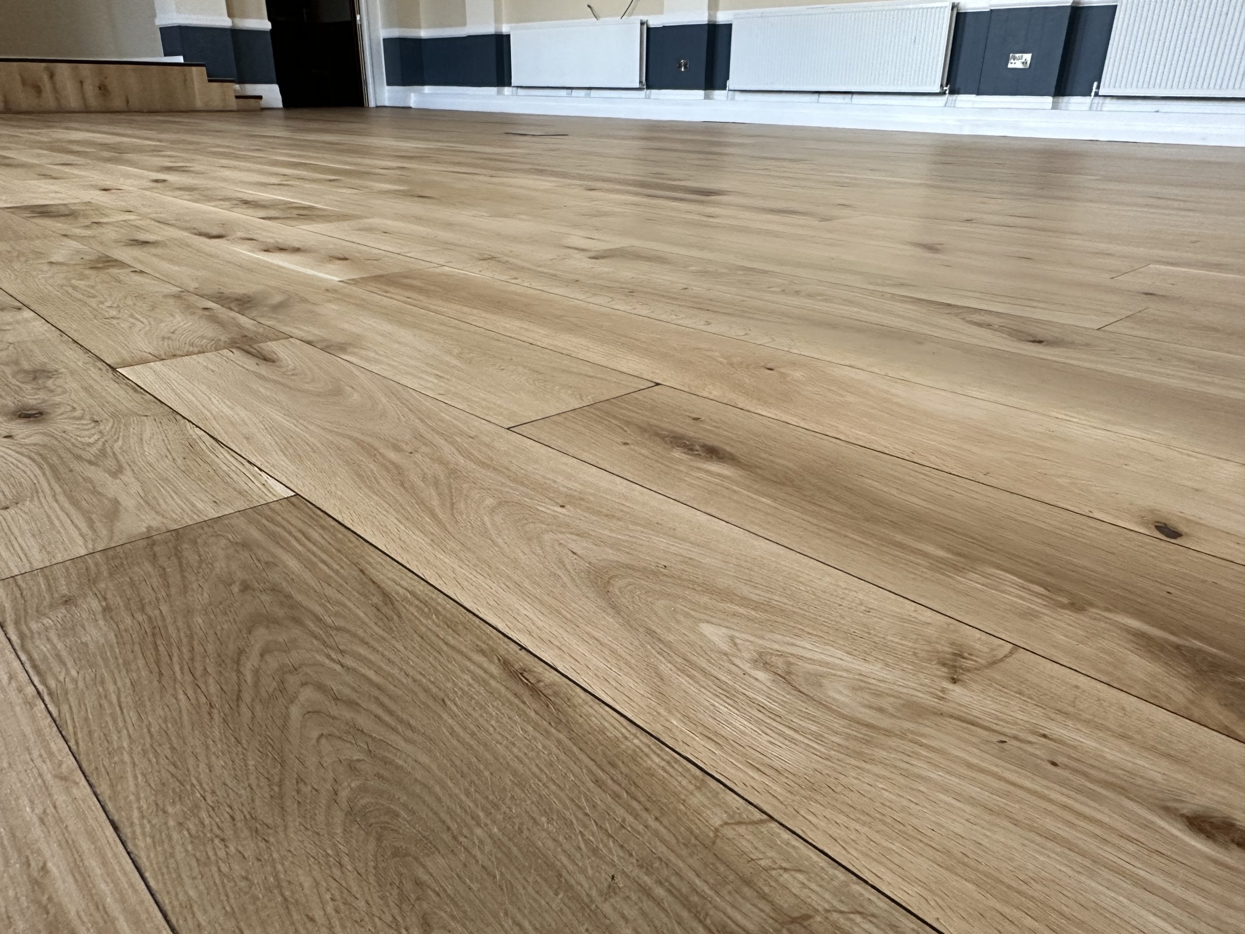 Large oak floor restored in a Masonic hall close up