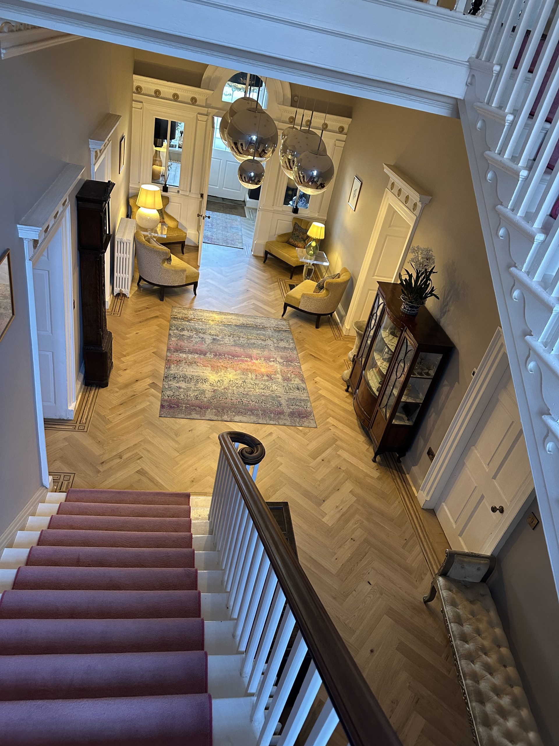 Bespoke Parquet Flooring From Staircase View from the staircase over finished oak parquet flooring and handmade decorative borders