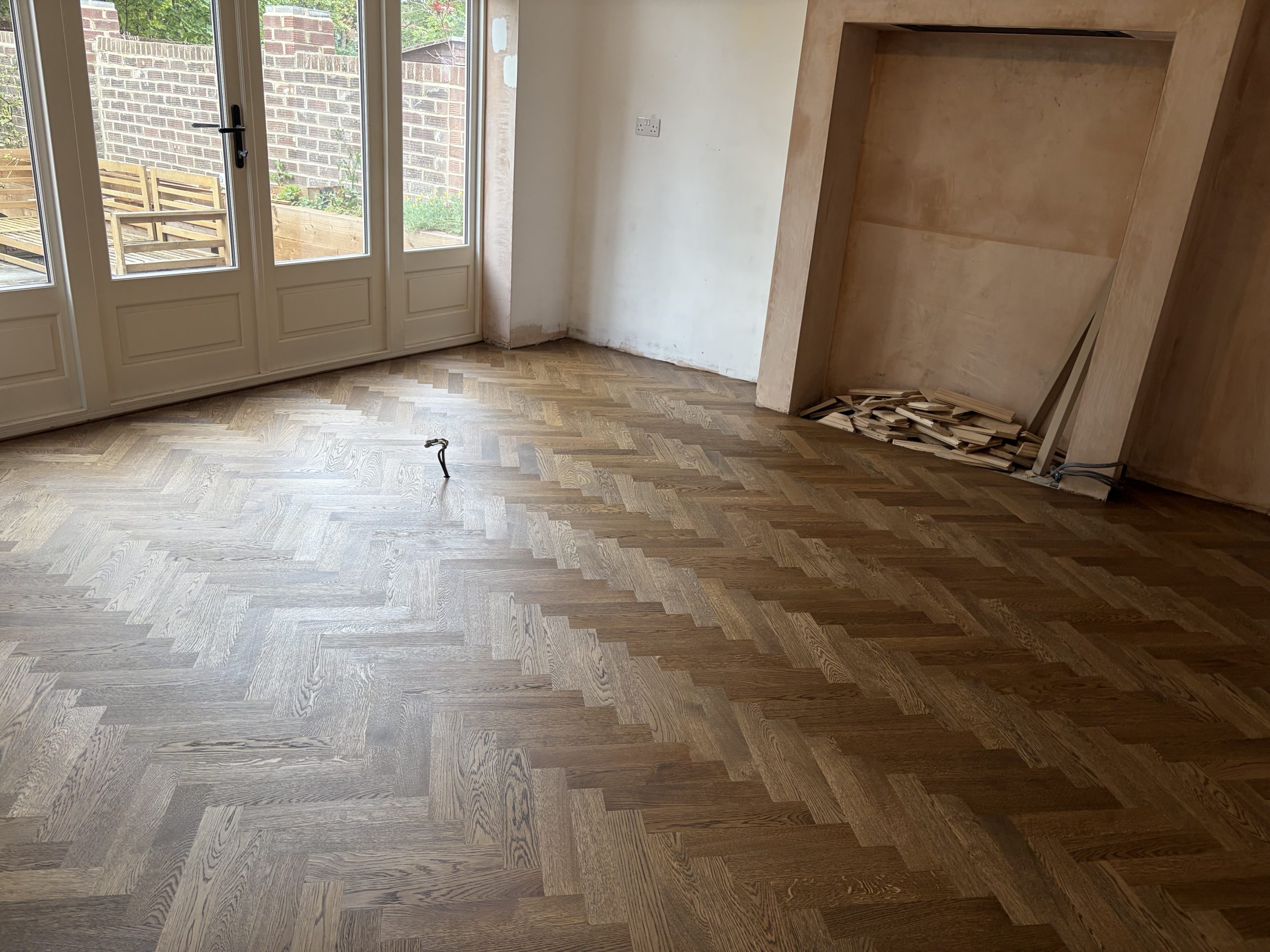 Finished Solid Oak Herringbone Floor – Tynemouth Finished solid oak herringbone flooring across a ground-floor living space in Tynemouth