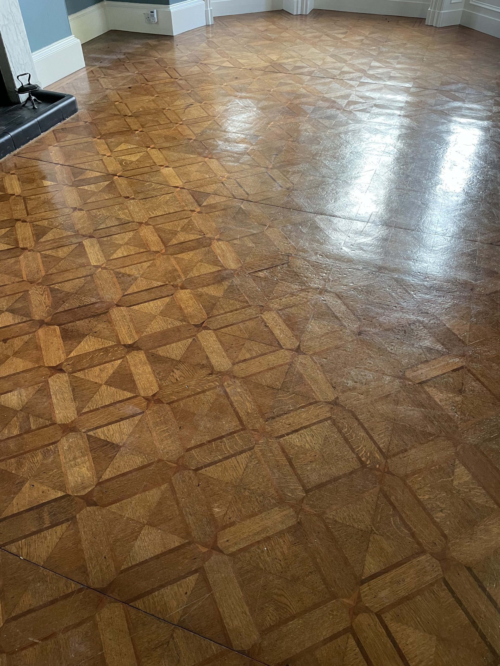 Worn geometric parquet flooring before restoration near Berwick-upon-Tweed