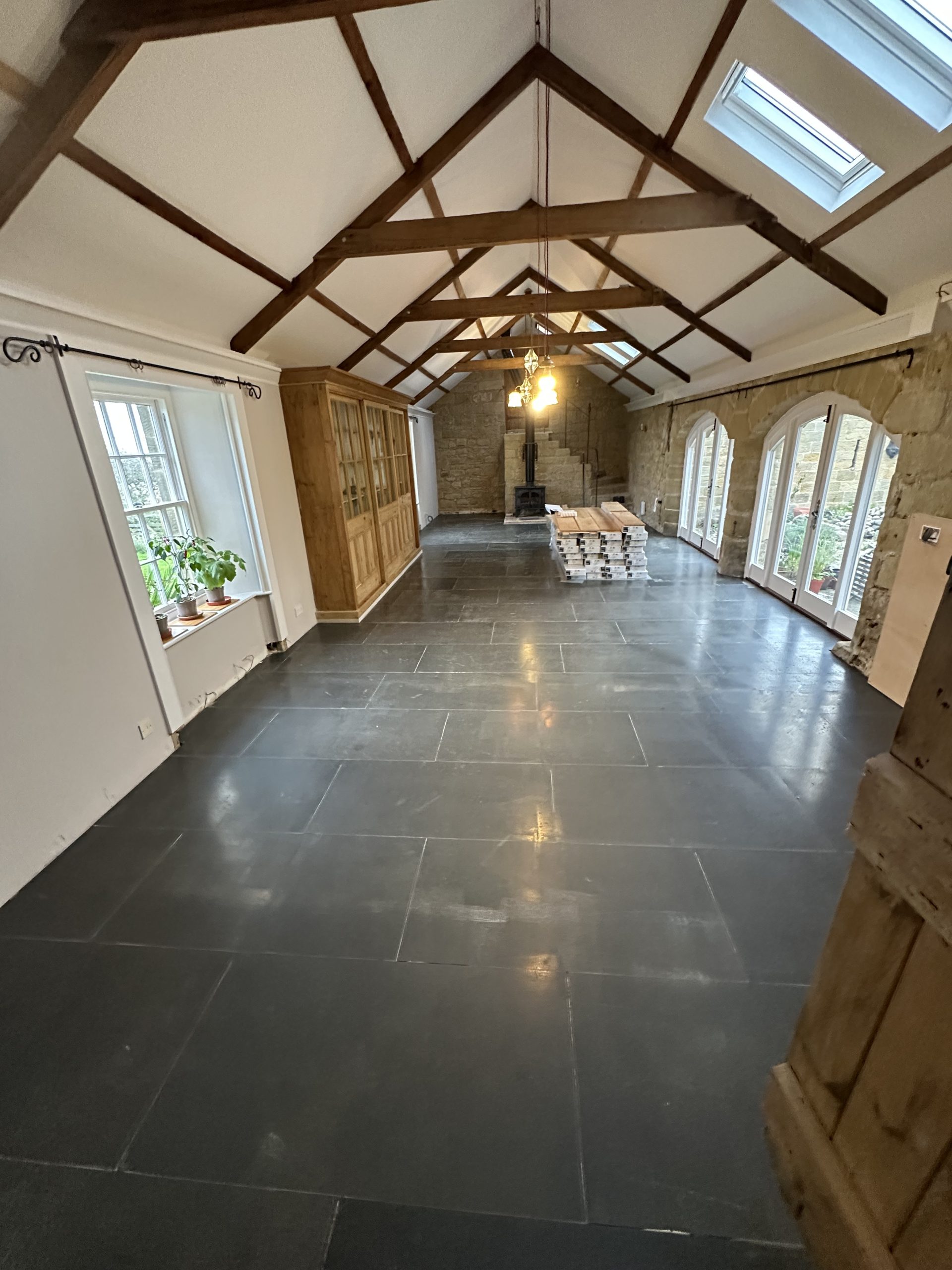 Original dark tiled floor before wide engineered oak flooring installation in High Buston, Northumberland